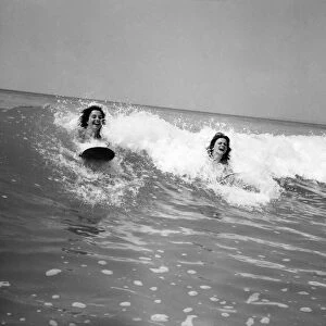 Women body boarding in the surf at Newquay June 1960 M4303-004