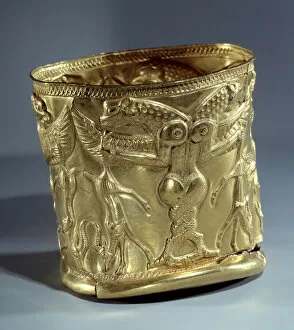 Oriental antique art: Electrum cup (gold and silver) representing a monster with intertwined greenhouses, around 1200 BC. From northern Iran. Paris, Musee Du Louvre